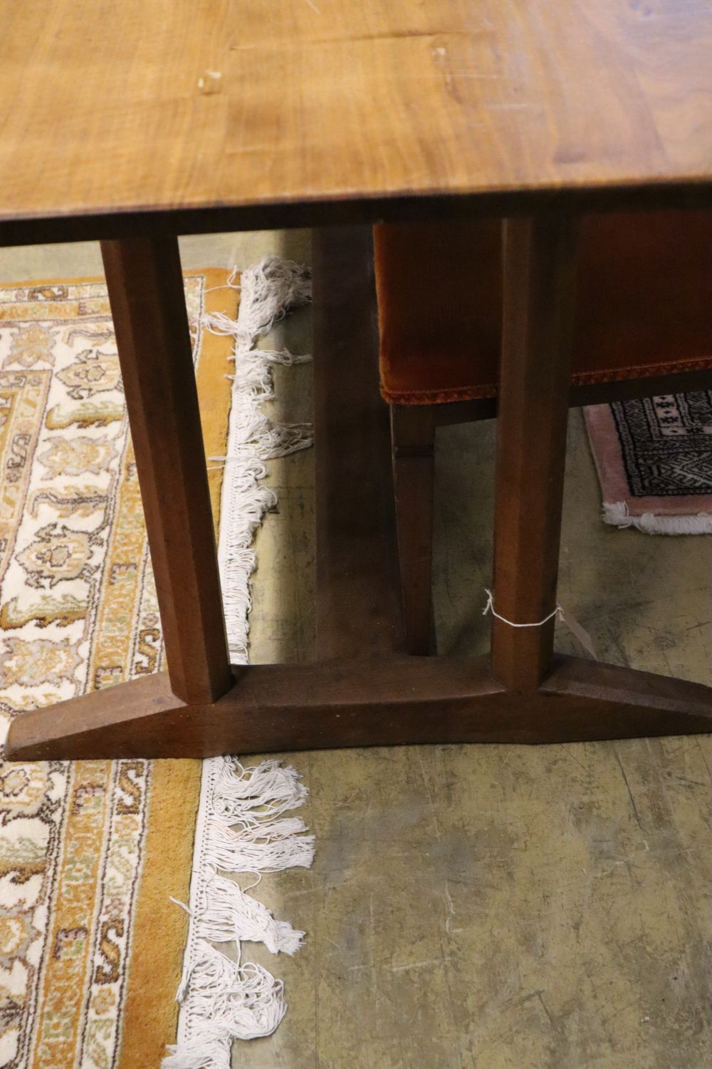 A Gordon Russell walnut dining table, circa 1930, on chamfered double end supports and central stretcher, width 184cm, depth 83cm, heig